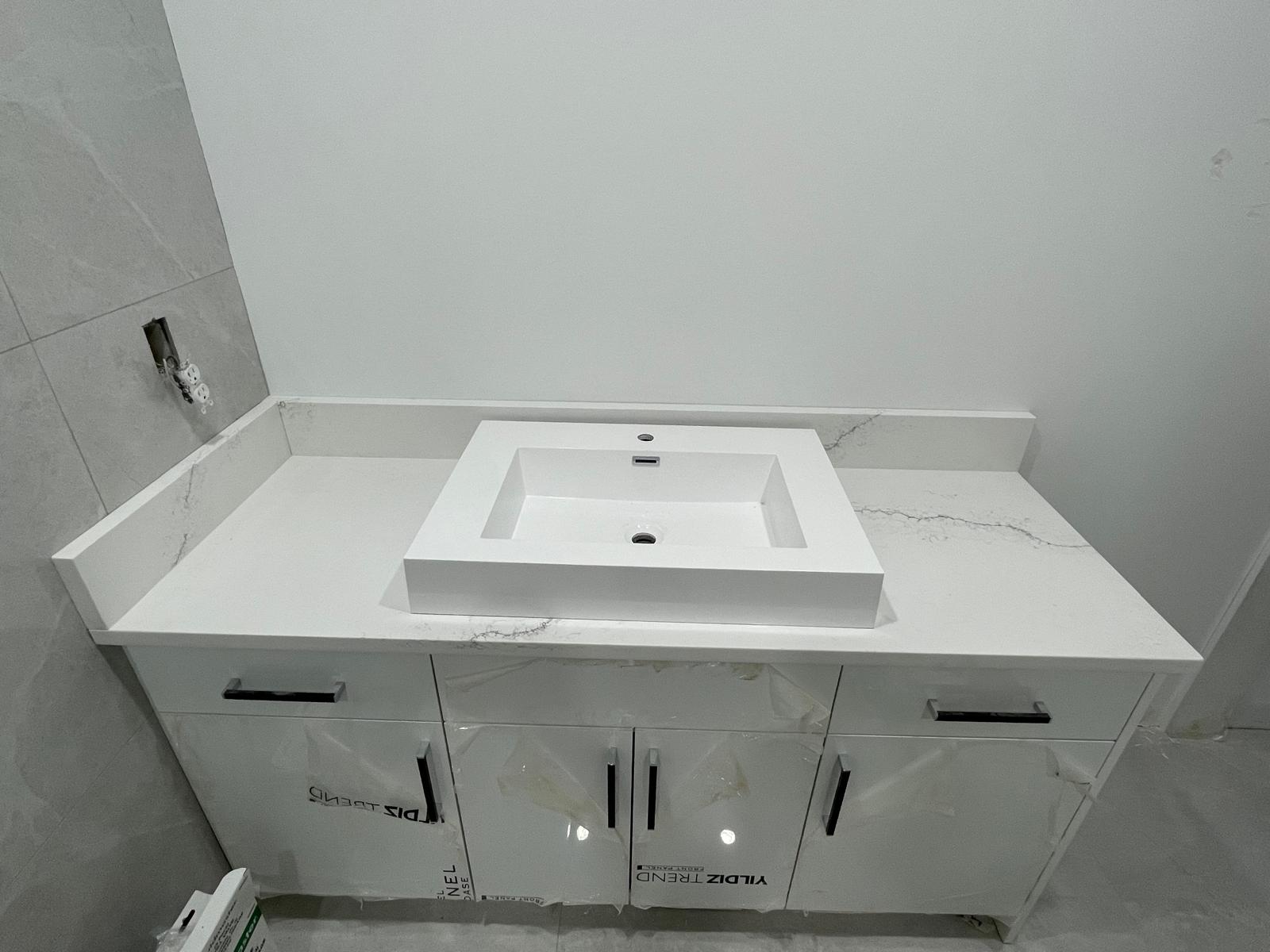 Modern white vanity with white quartz countertop and rectangular vessel sink