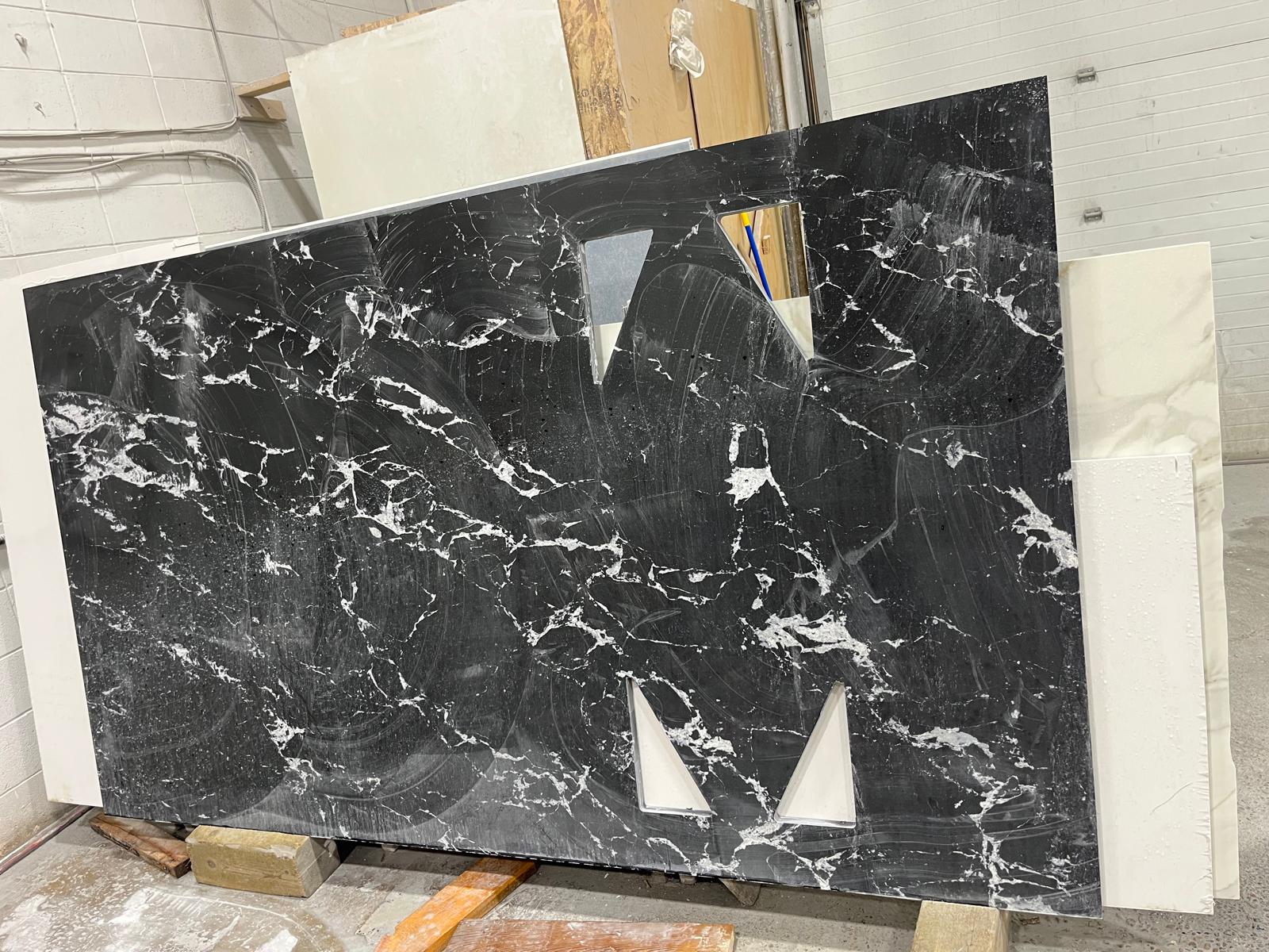Black Marquina marble slab with white veining in the fabrication shop