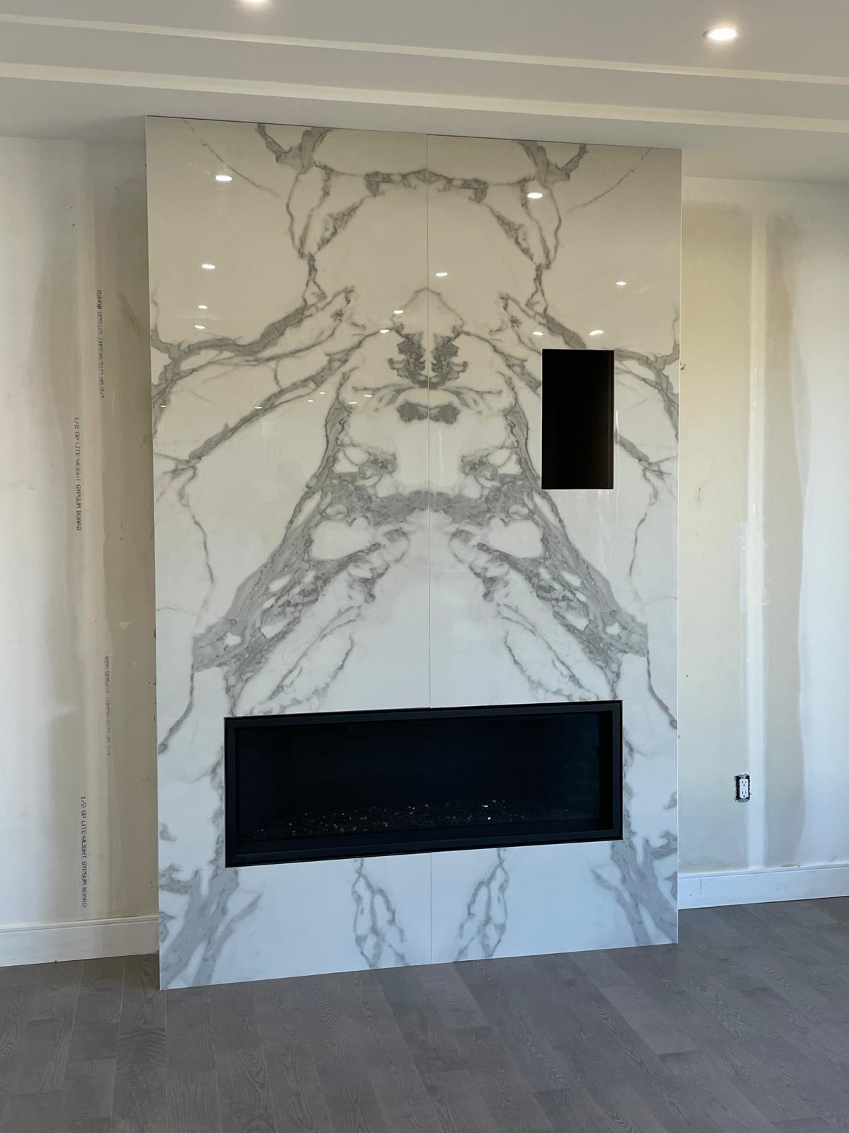 Bookmatched white marble feature wall with linear fireplace insert