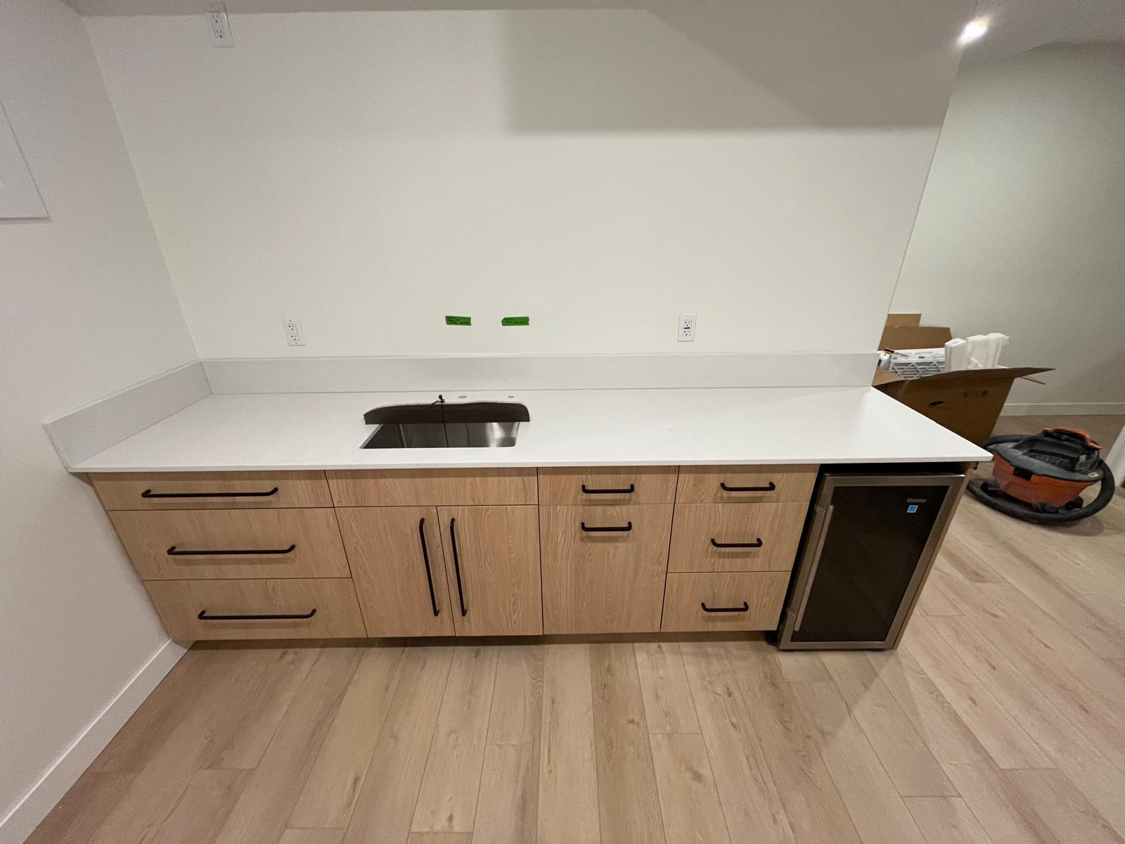 Bar and prep area with white quartz countertop and undermount sink