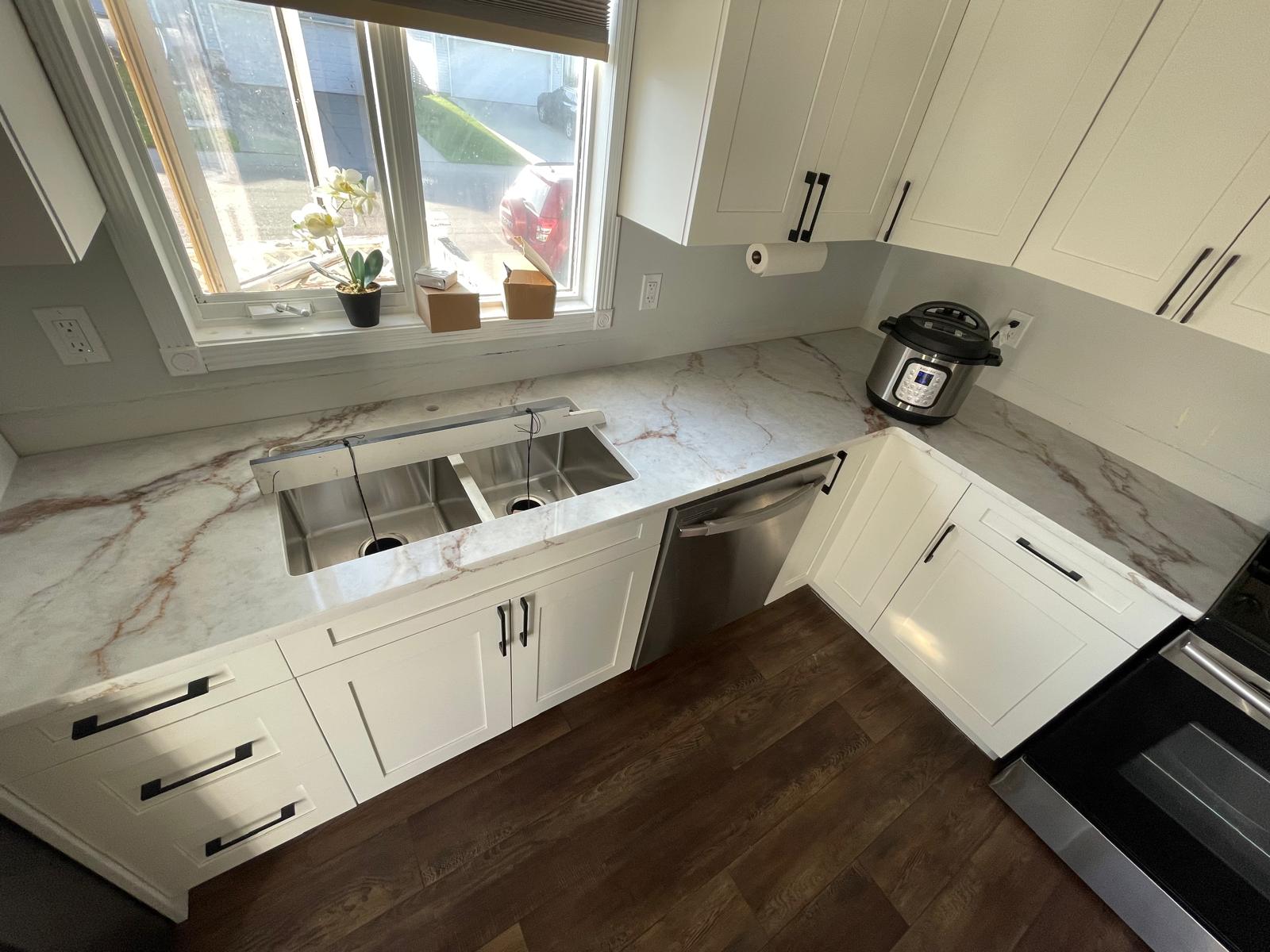 White shaker kitchen with marble-look quartz countertop and double undermount sink